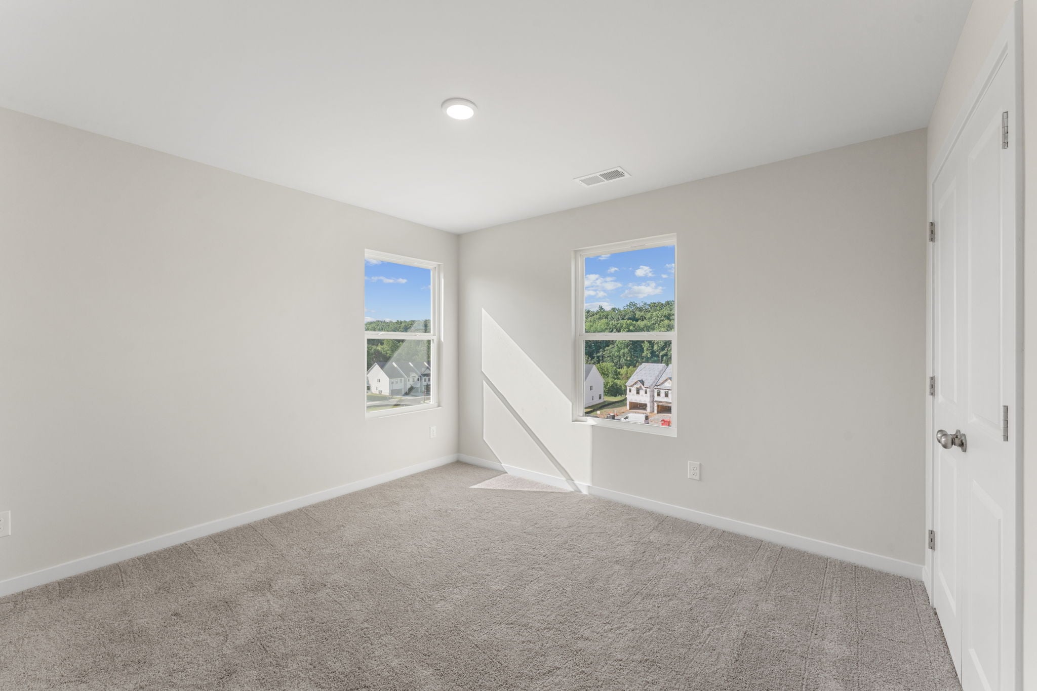 A room with a window and a staircase.