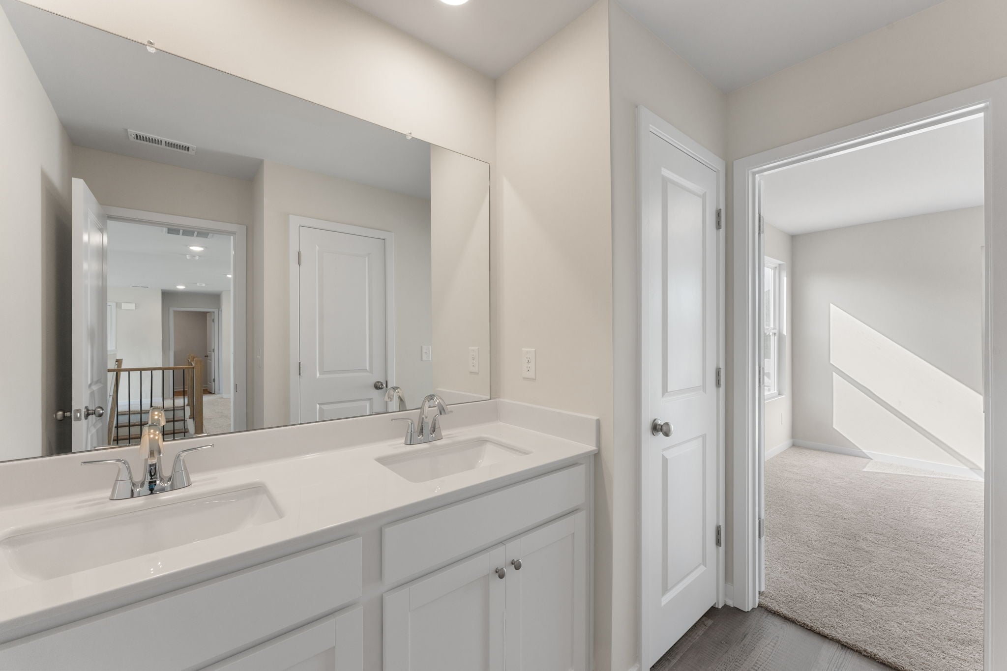 A bathroom with a large mirror.