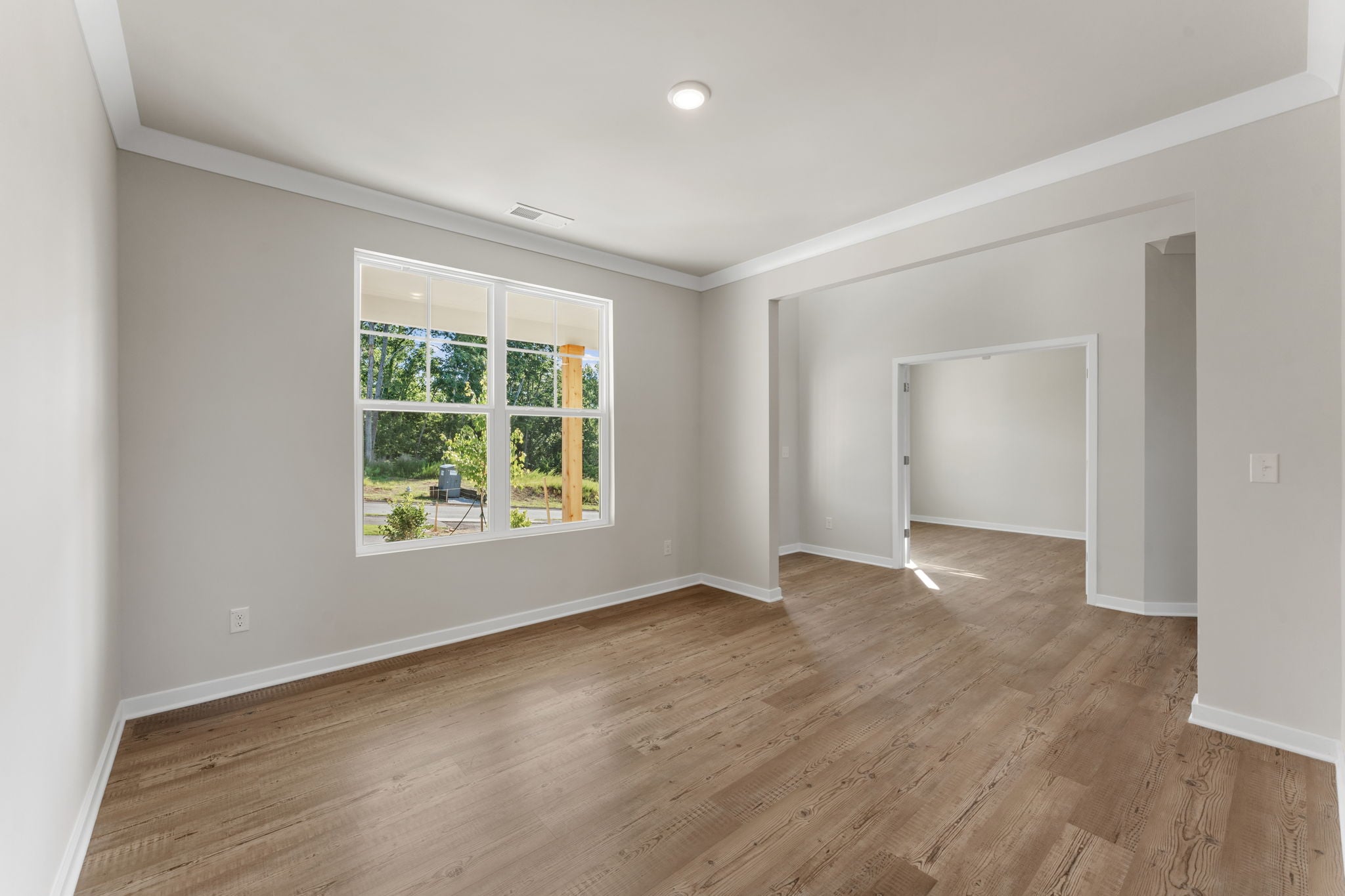 A room with a wood floor and a window.
