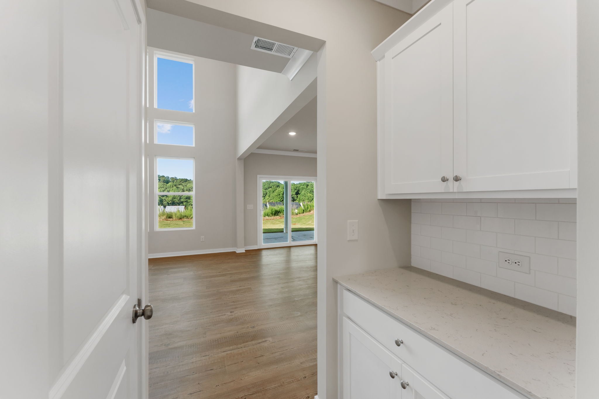 A kitchen with white cabinets.