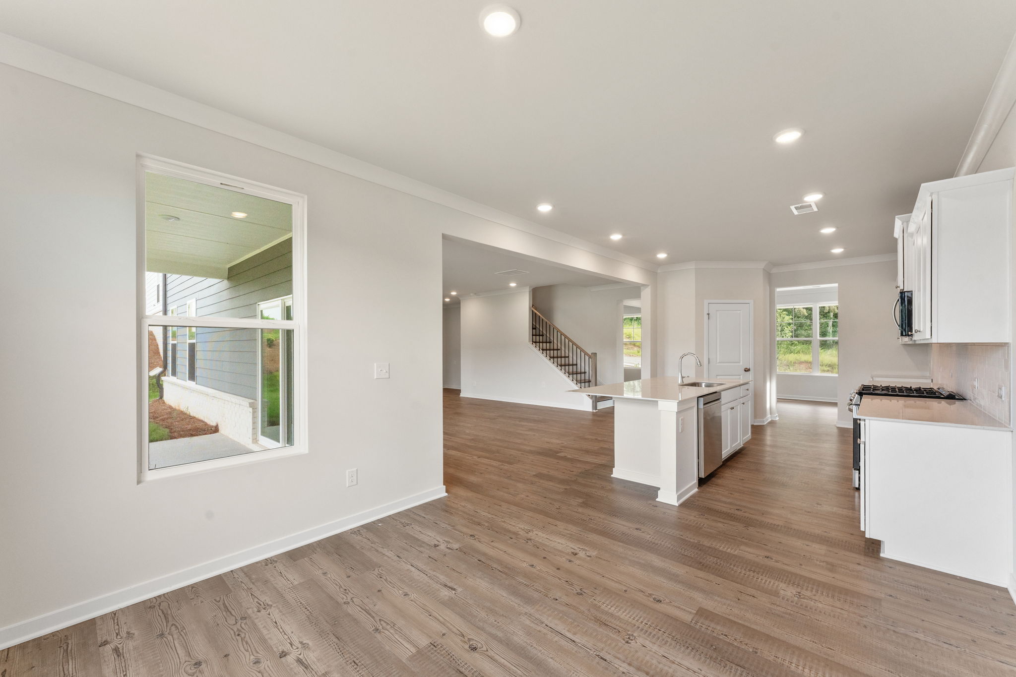 A large white room with a wood floor and a wood floor.
