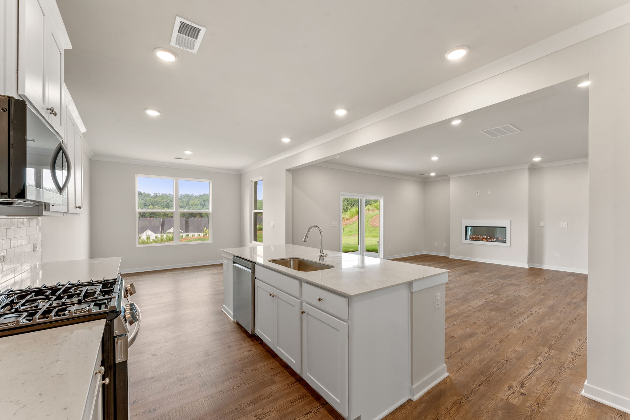 A kitchen with white cabinets.