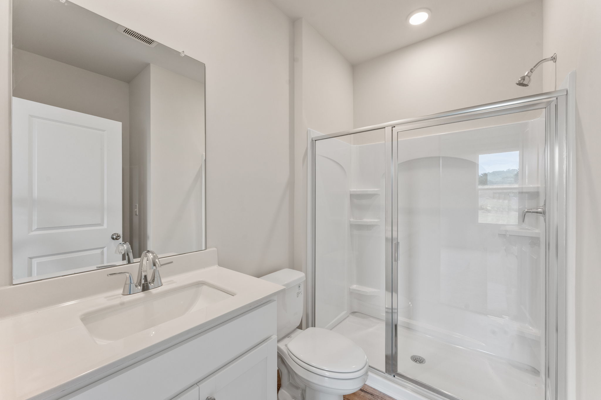 A bathroom with a glass shower.
