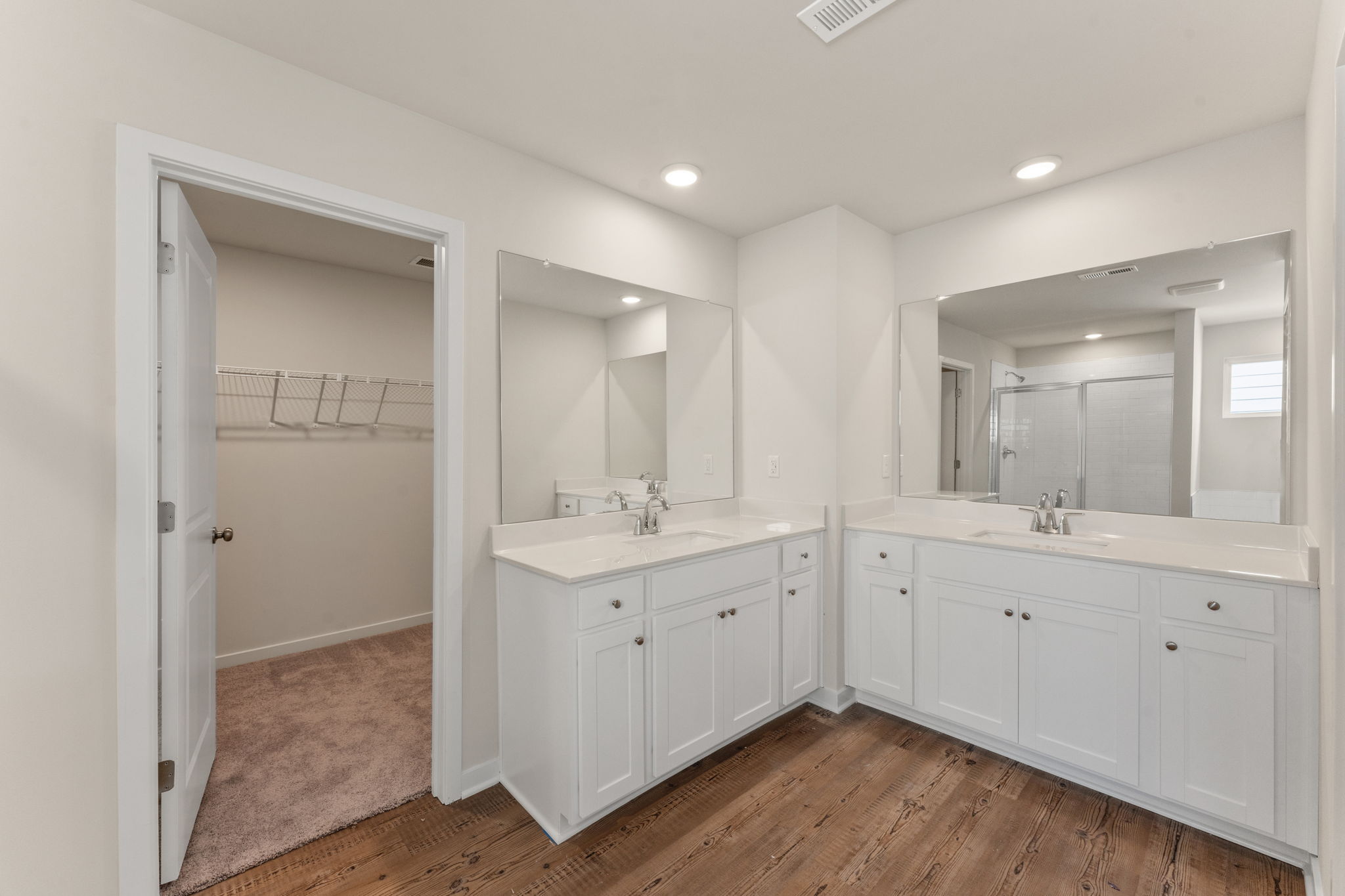 A bathroom with white cabinets.
