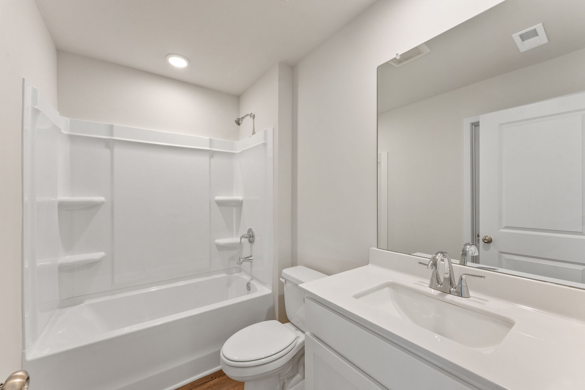 A bathroom with a tub sink and toilet.