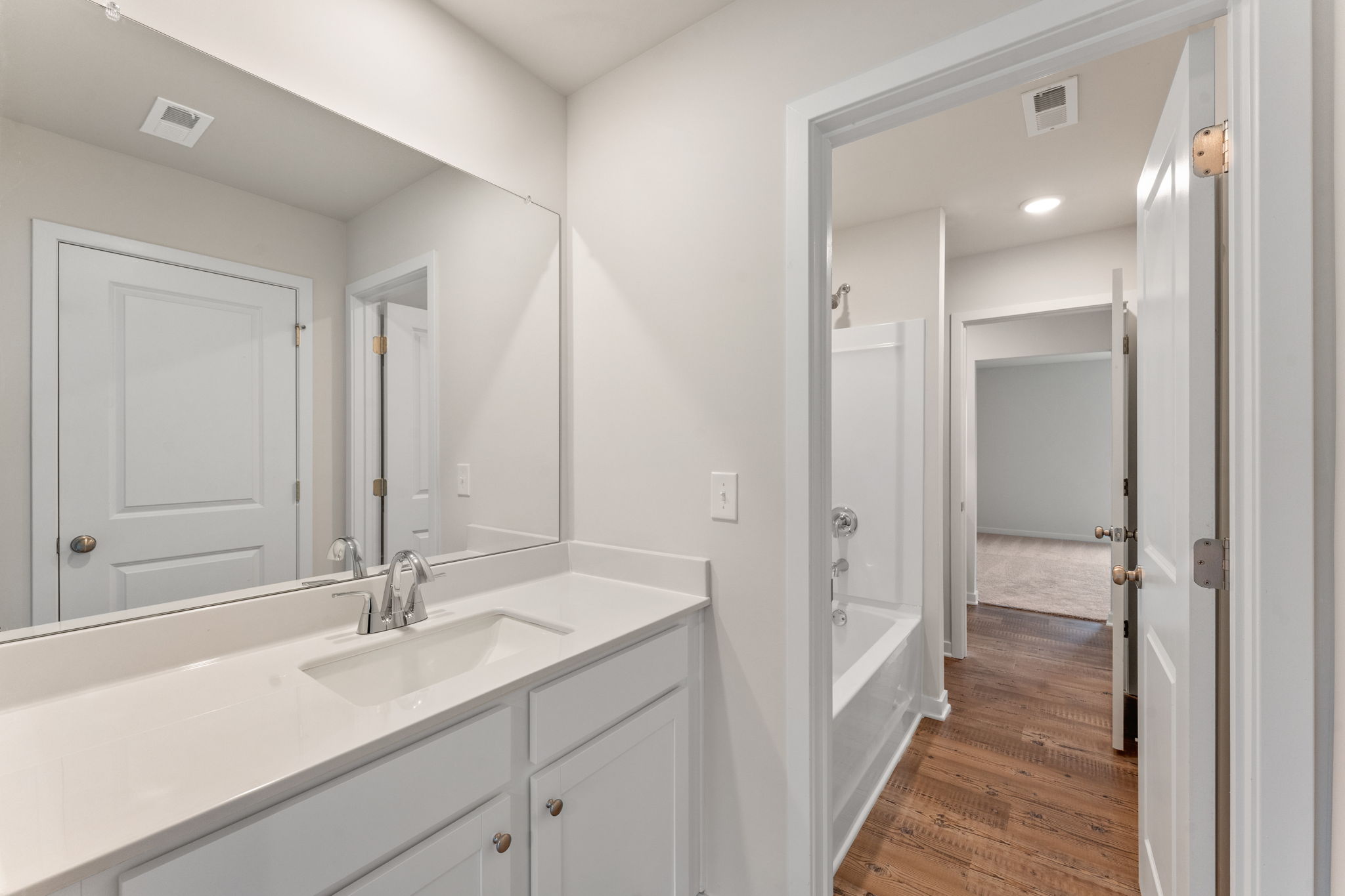 A bathroom with a sink and a shower.