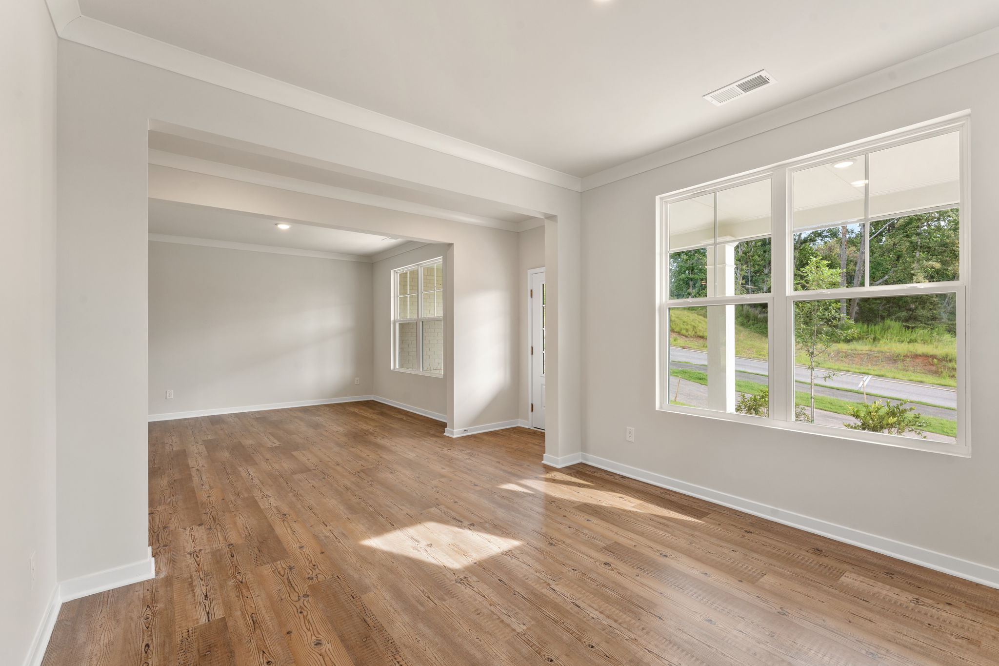 A room with a wood floor and a window.