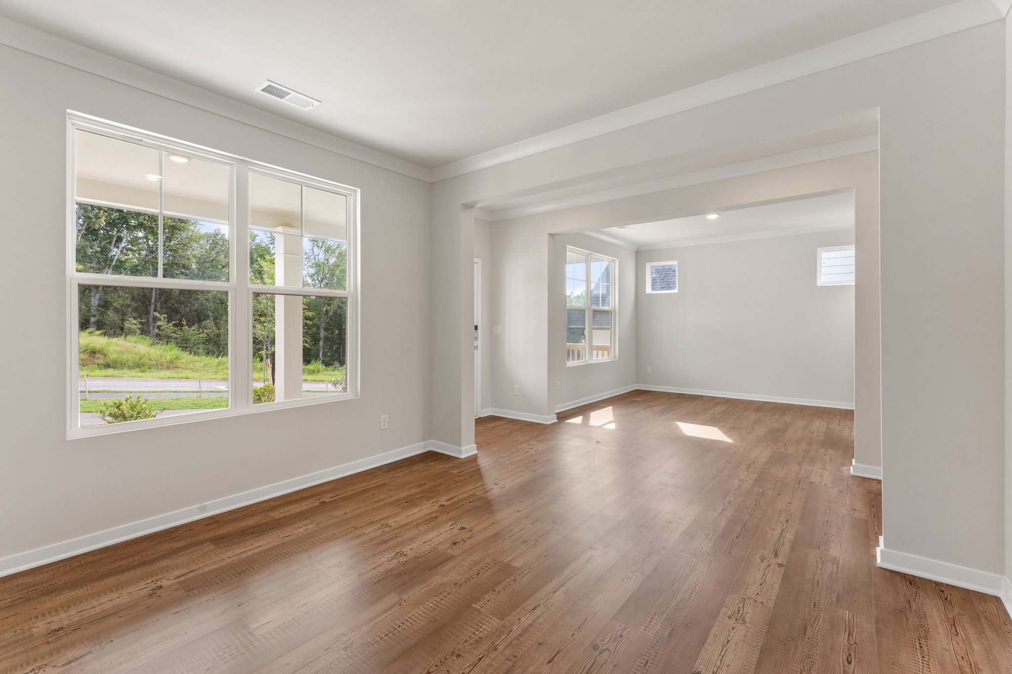A room with a wood floor and a window.