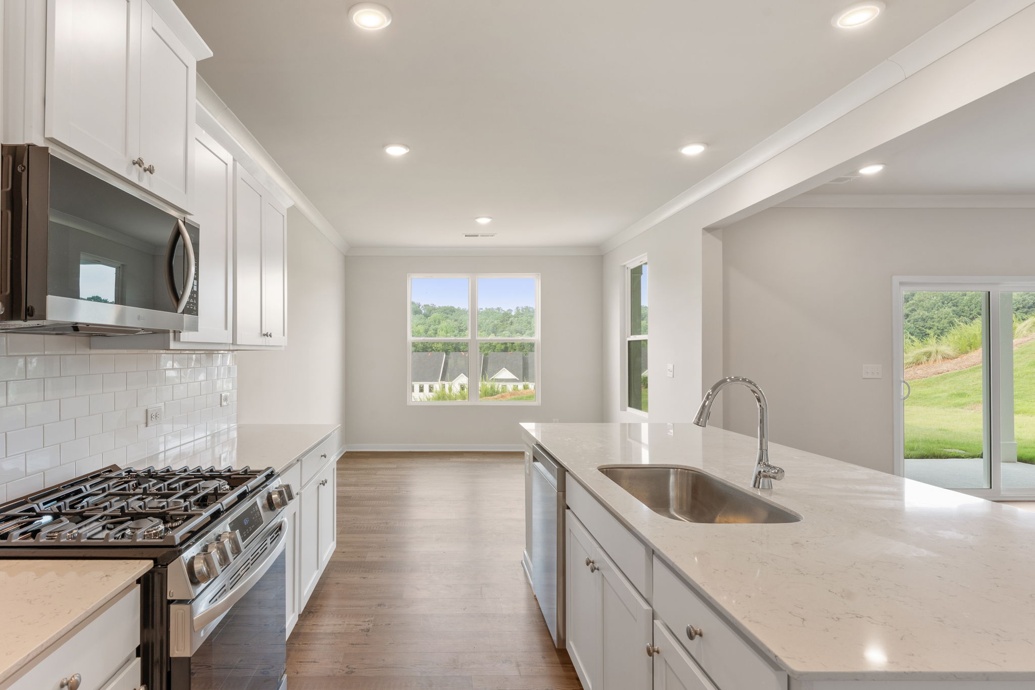 A kitchen with white cabinets.