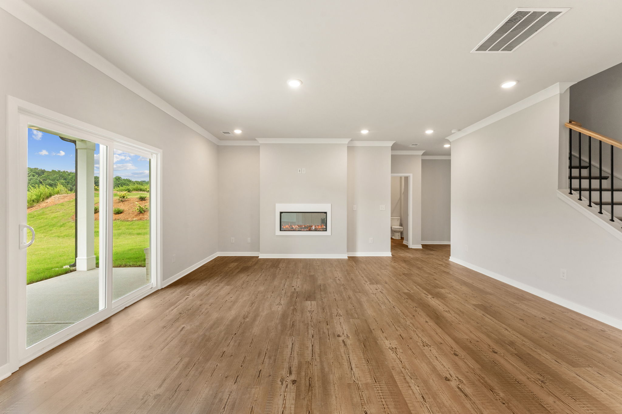 A room with white walls and a wood floor.