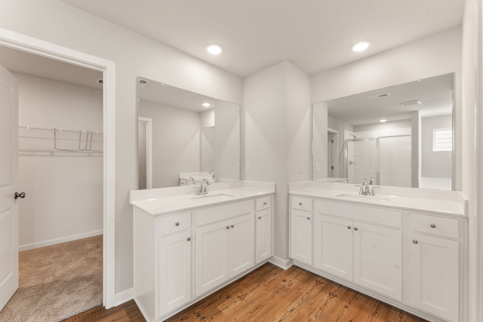 A bathroom with white cabinets.