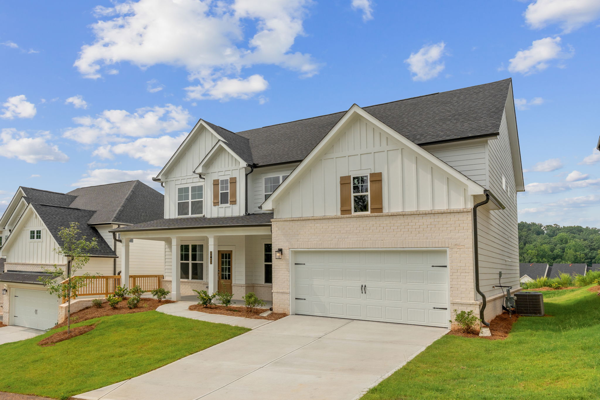 A house with a garage with Southfork Ranch in the background.
