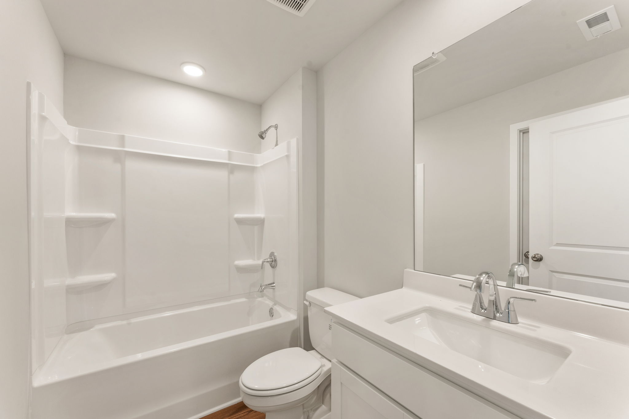 A bathroom with a tub sink and toilet.