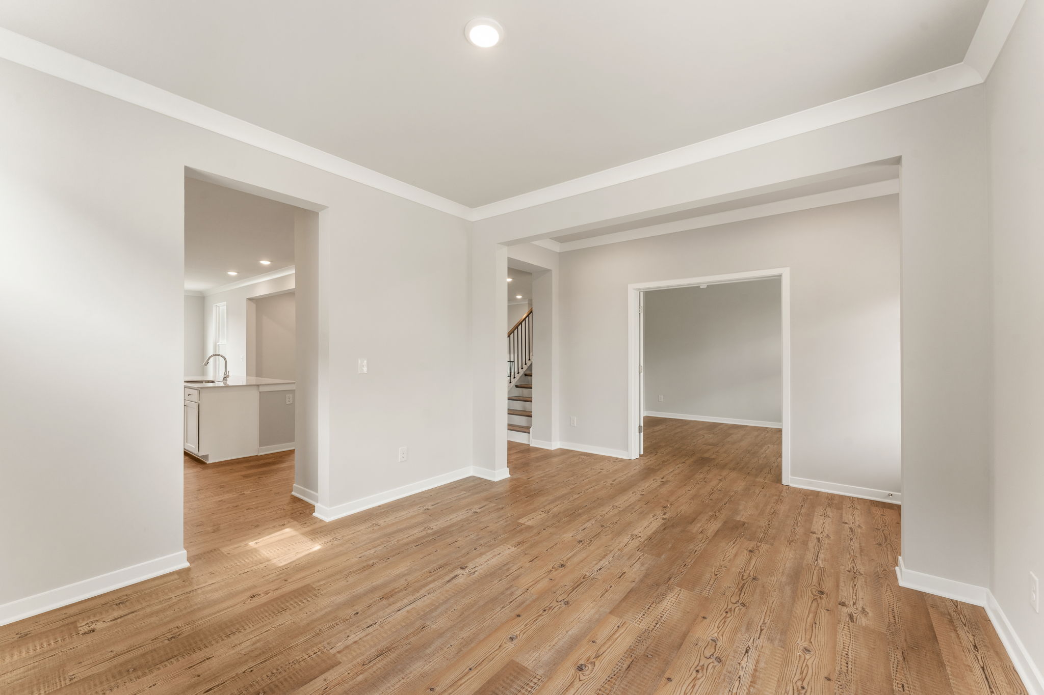A room with a wood floor and white walls.