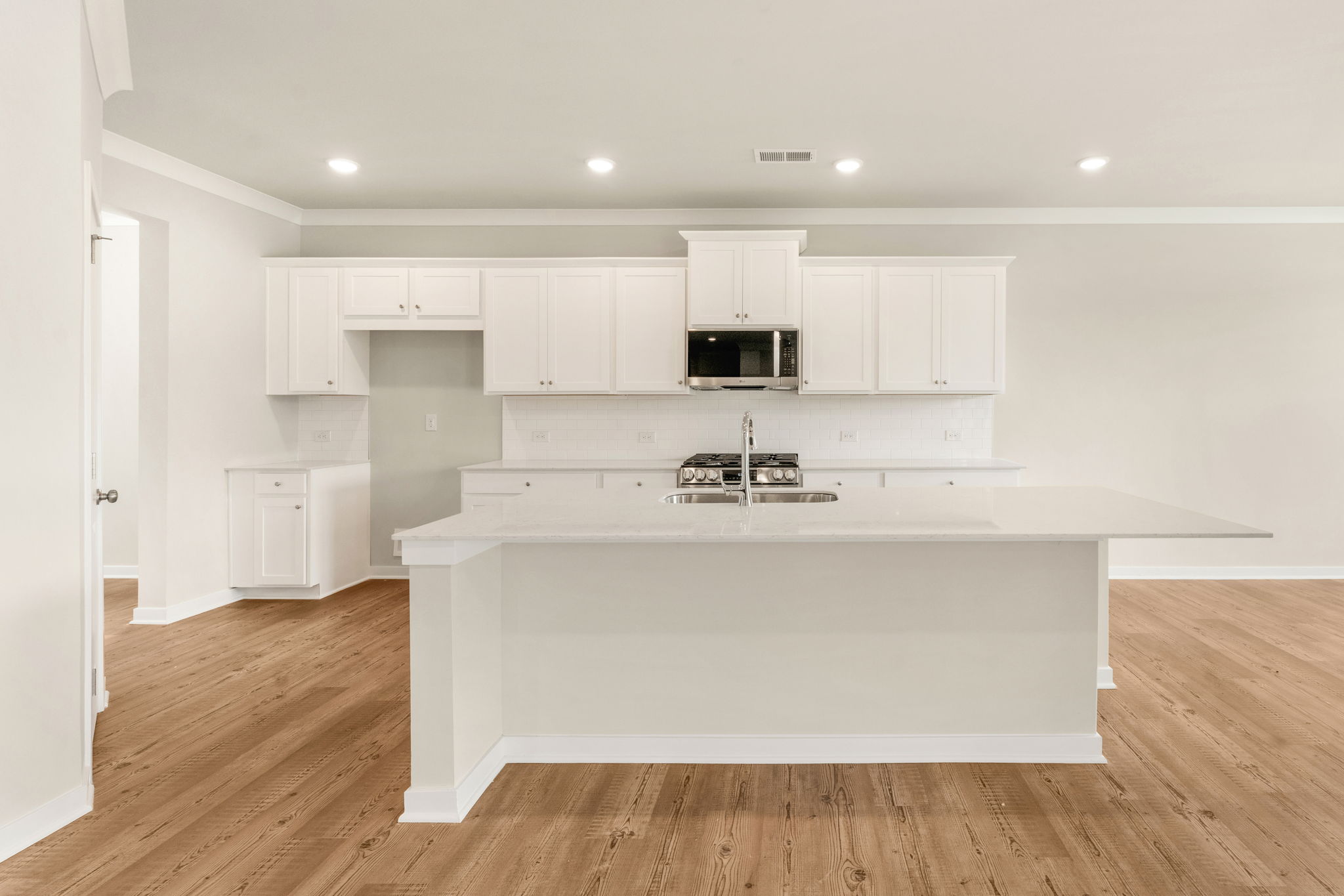 A kitchen with white cabinets.