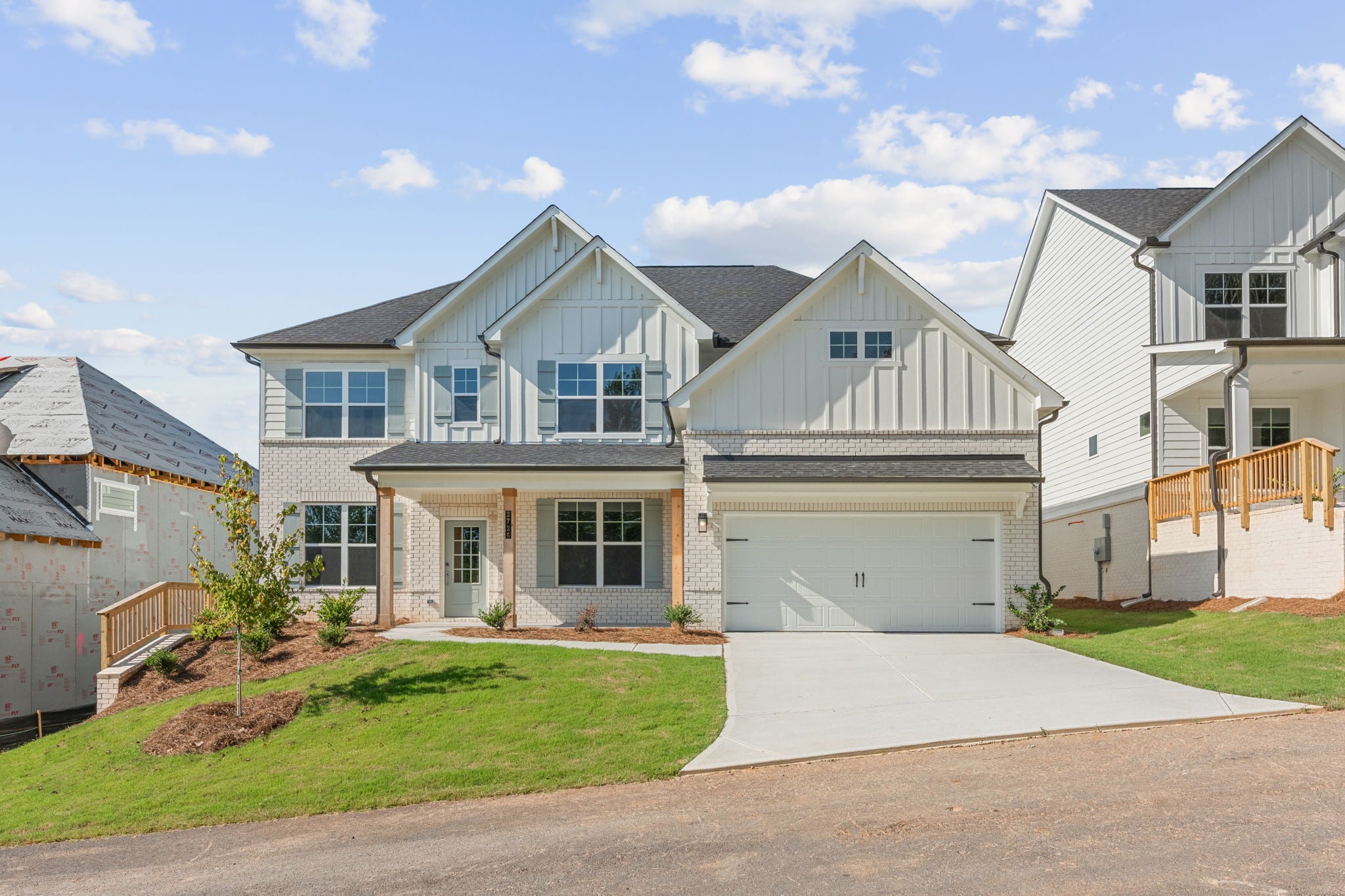 A house with a garage with Southfork Ranch in the background.