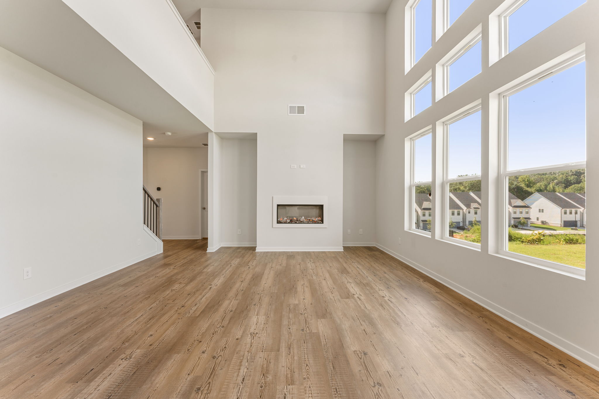 A room with a wood floor and windows.