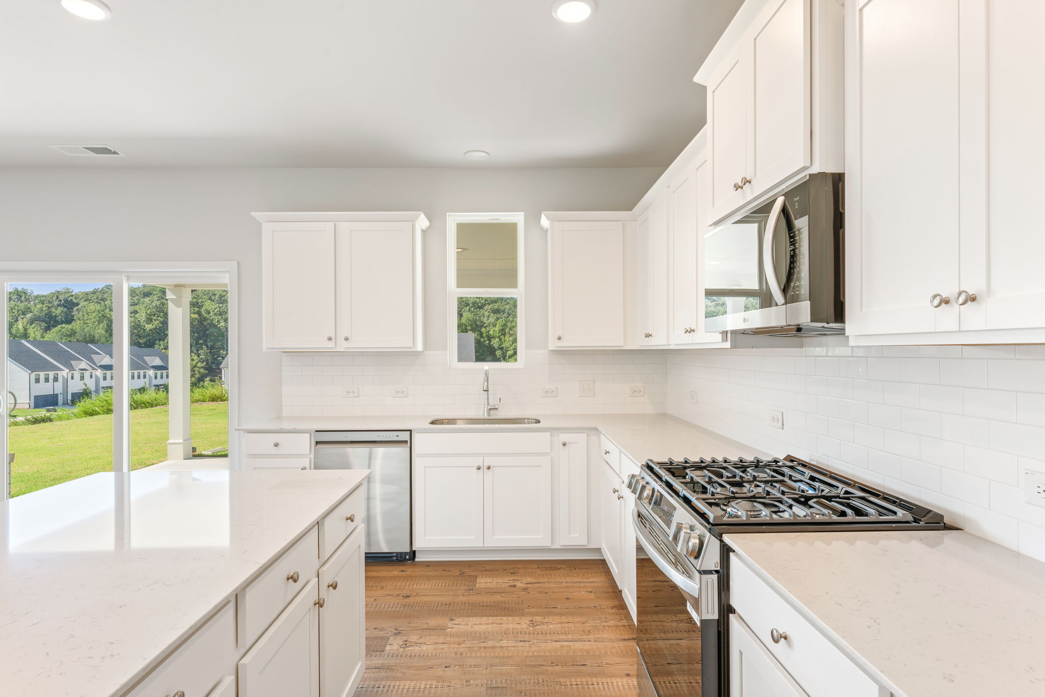 A kitchen with white cabinets.