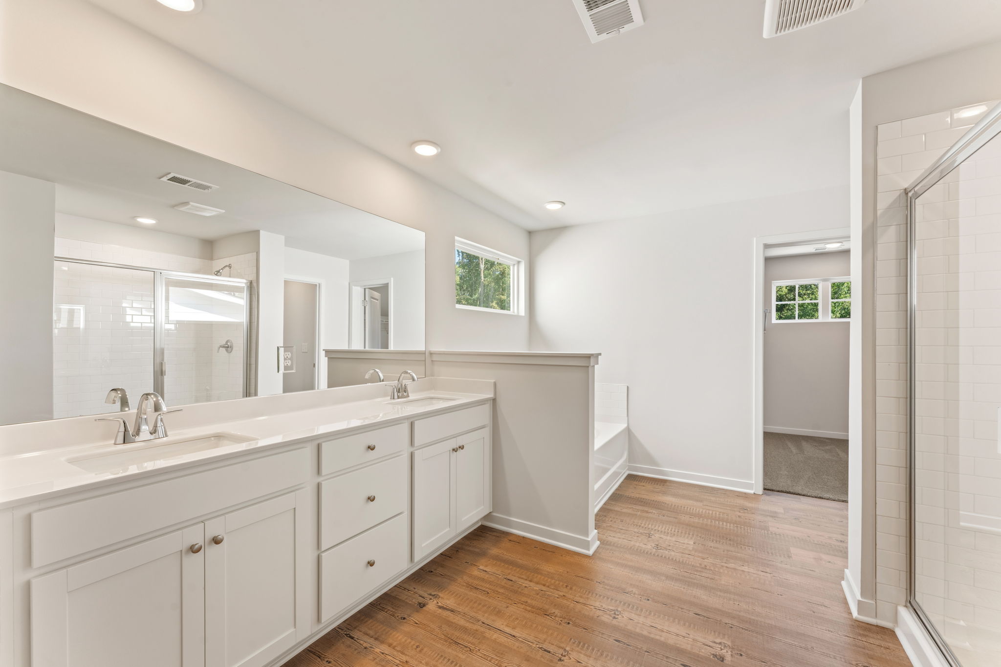 A bathroom with white cabinets.