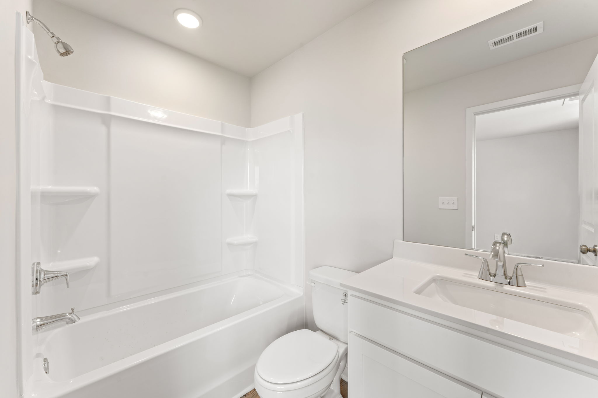 A bathroom with a tub toilet and sink.