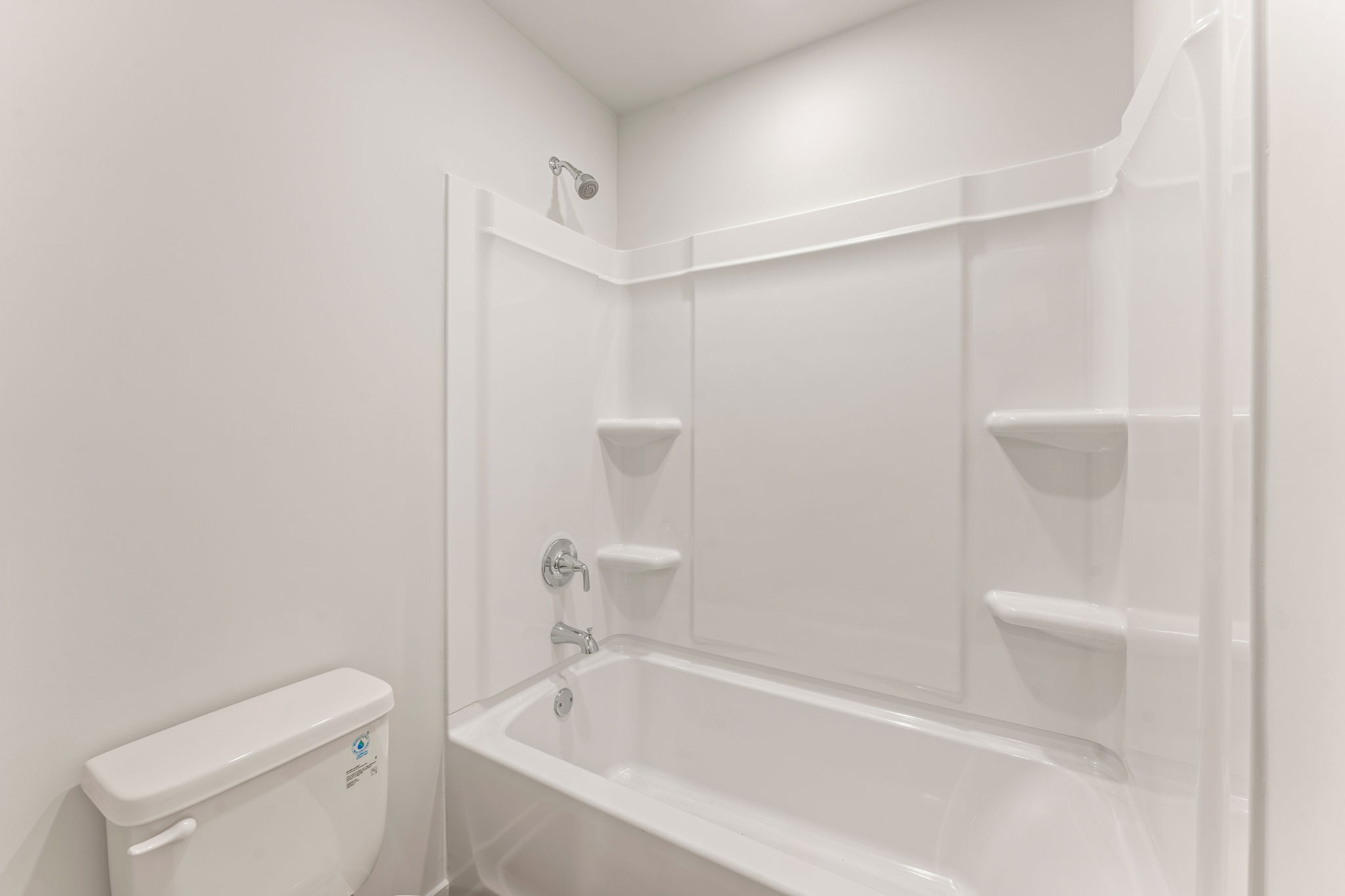 A bathroom with a tub toilet and sink.