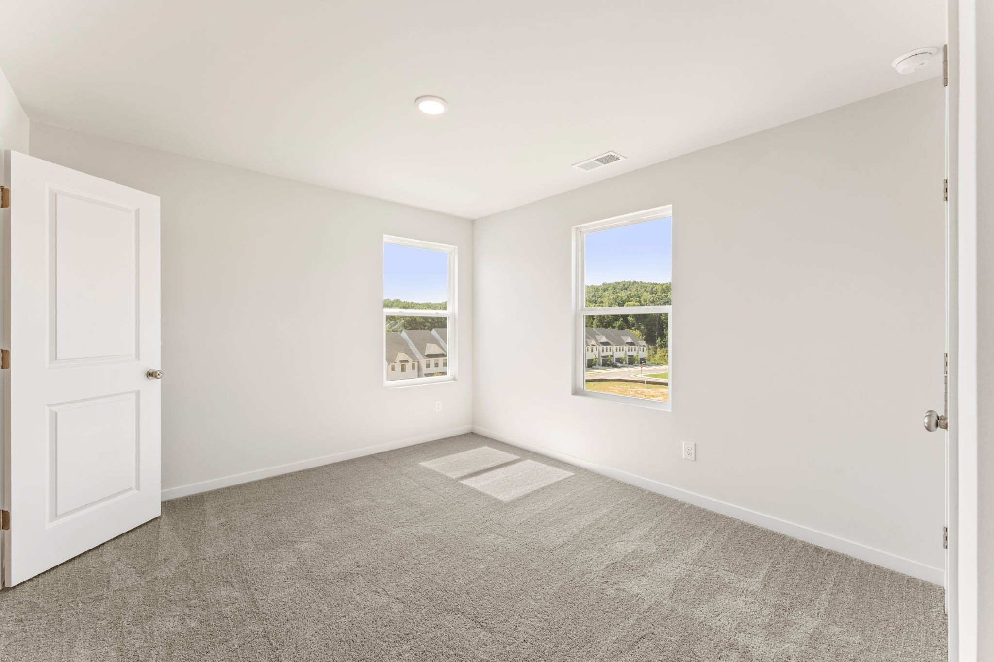 A room with white walls and a window.
