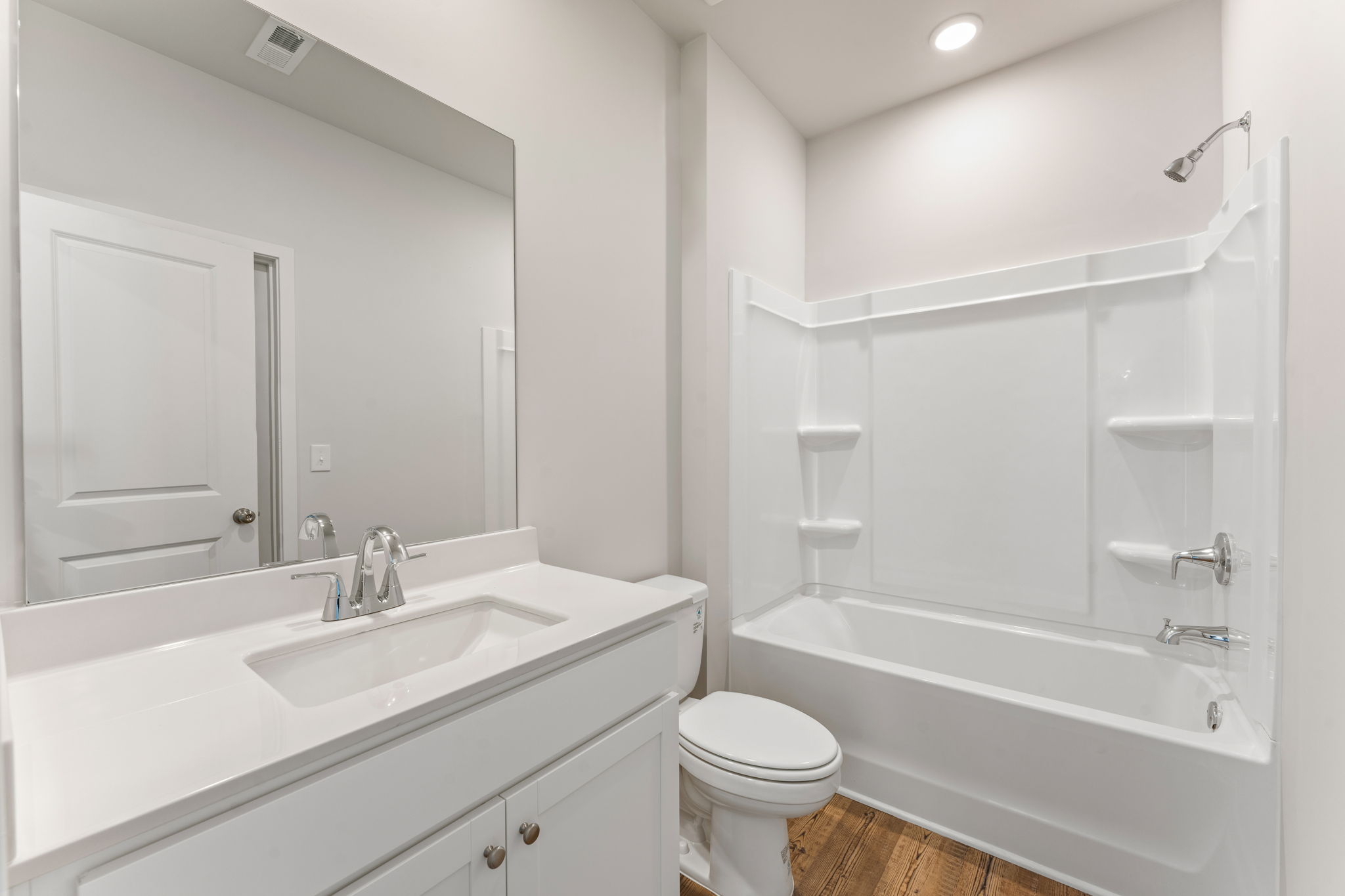 A bathroom with a tub sink and toilet.