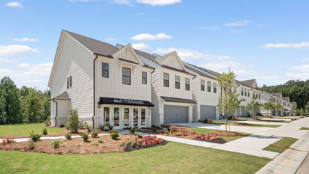 A large white house with a lawn.