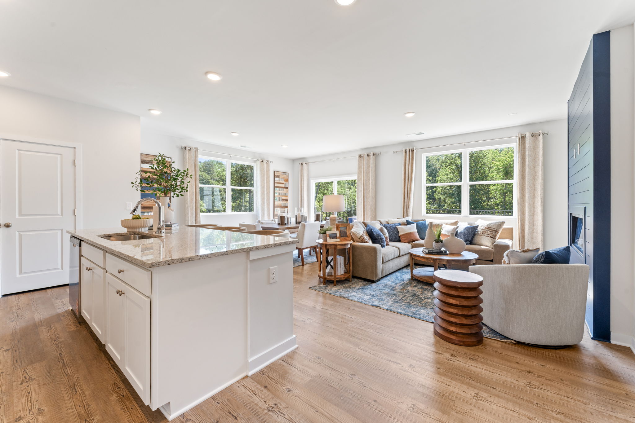 A large living room with a large kitchen island.