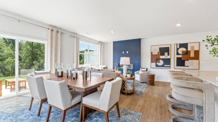 A large dining room with a large table and chairs.
