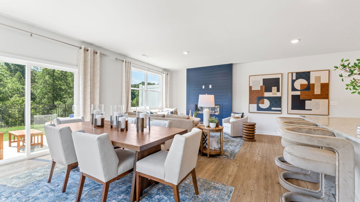 A large dining room with a large table and chairs.
