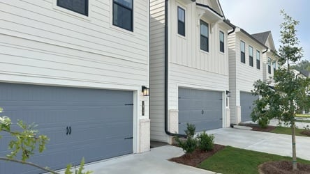 A white house with a garage.