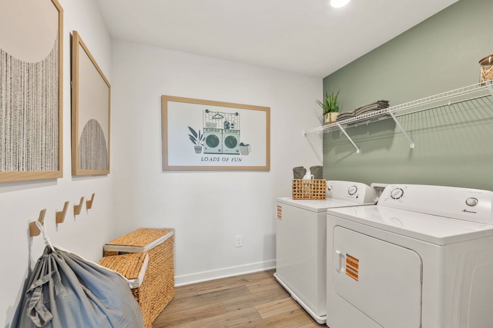A white laundry room with a washer and dryer.