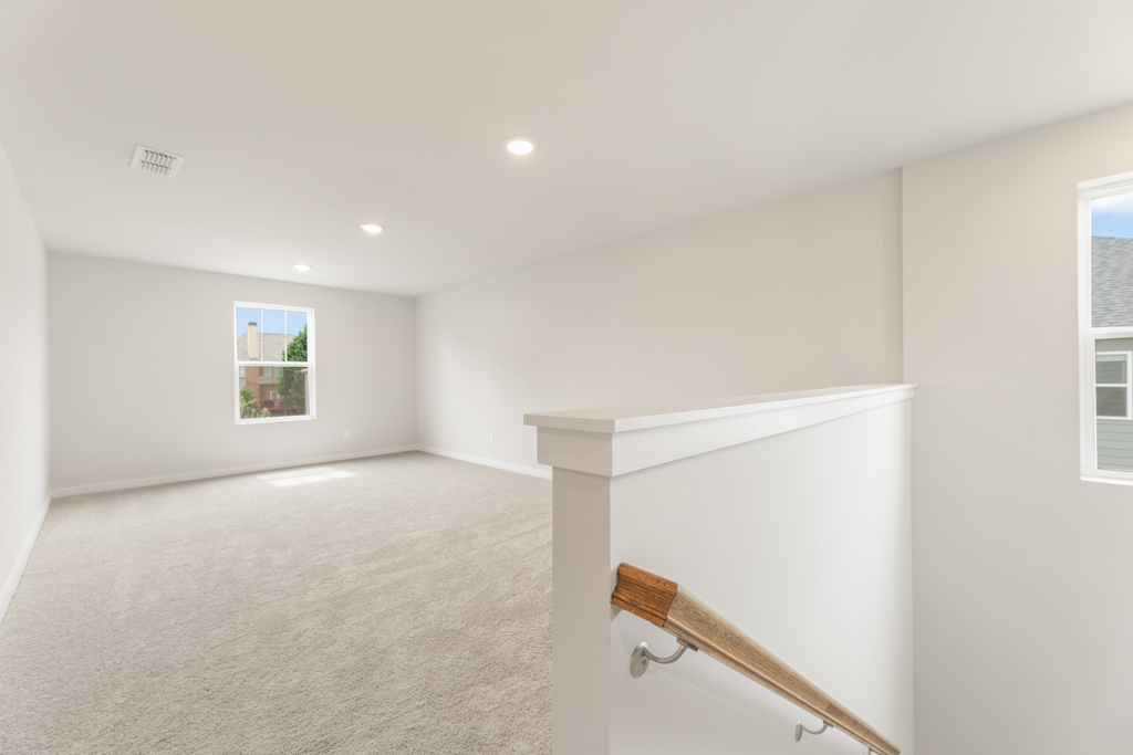 A room with a staircase and a window.