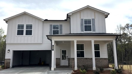 A white house with a garage.