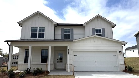 A white house with a garage.