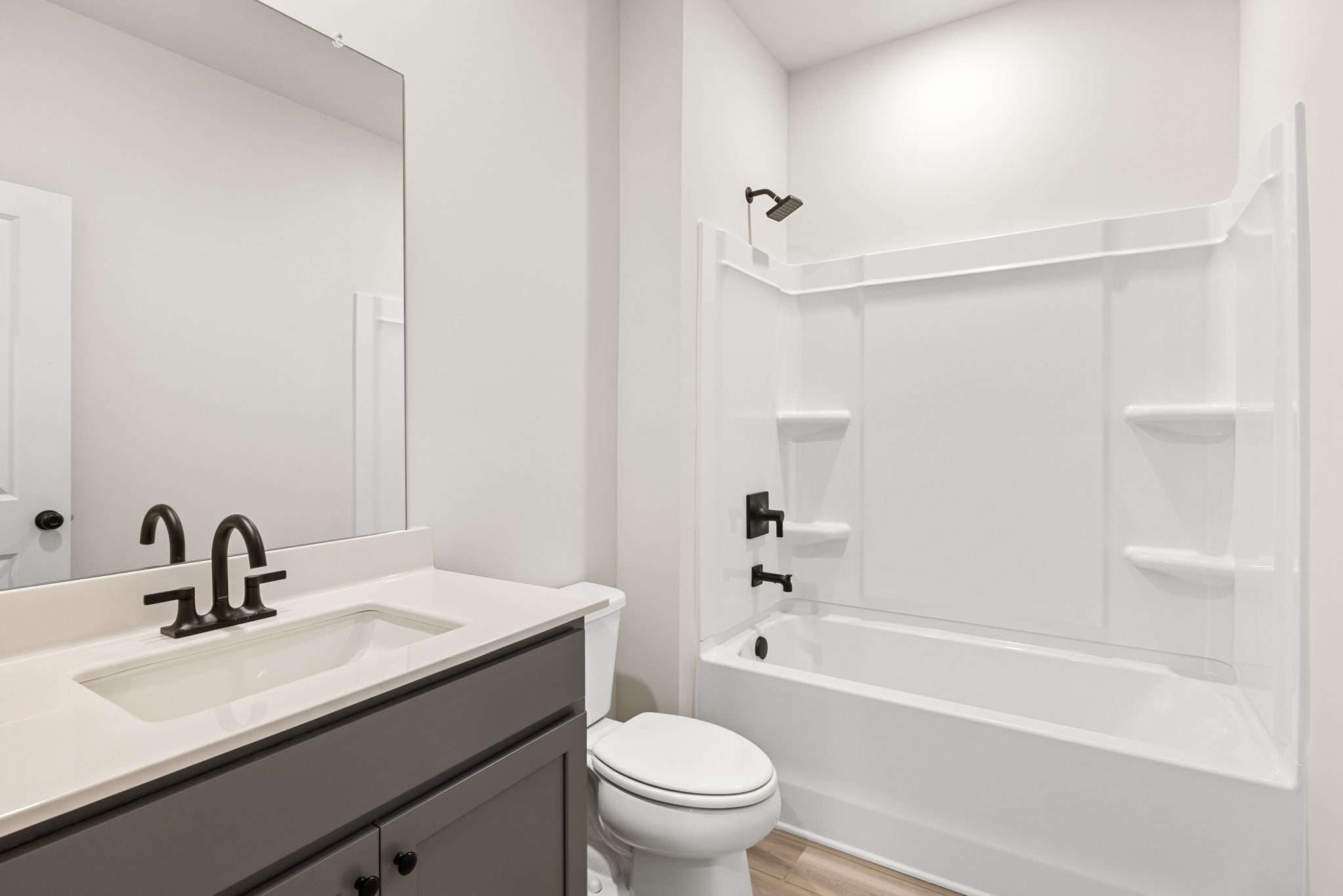 A bathroom with a sink toilet and bathtub.