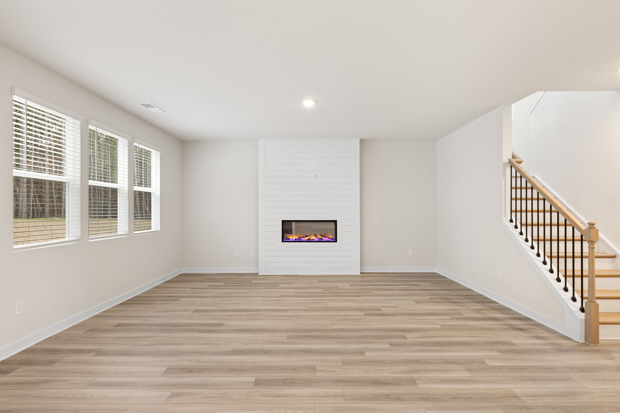A room with a fireplace and a staircase.