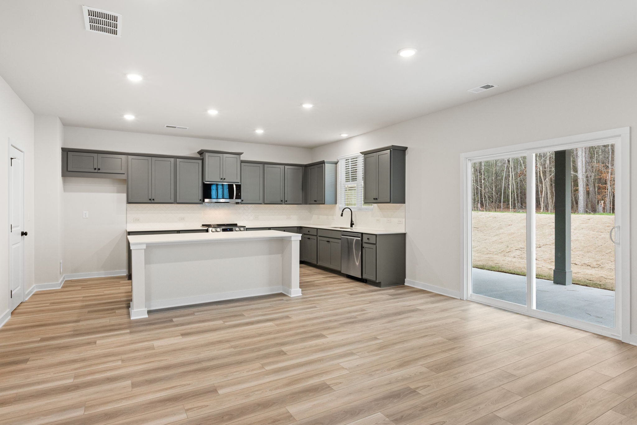 A kitchen with a wood floor.