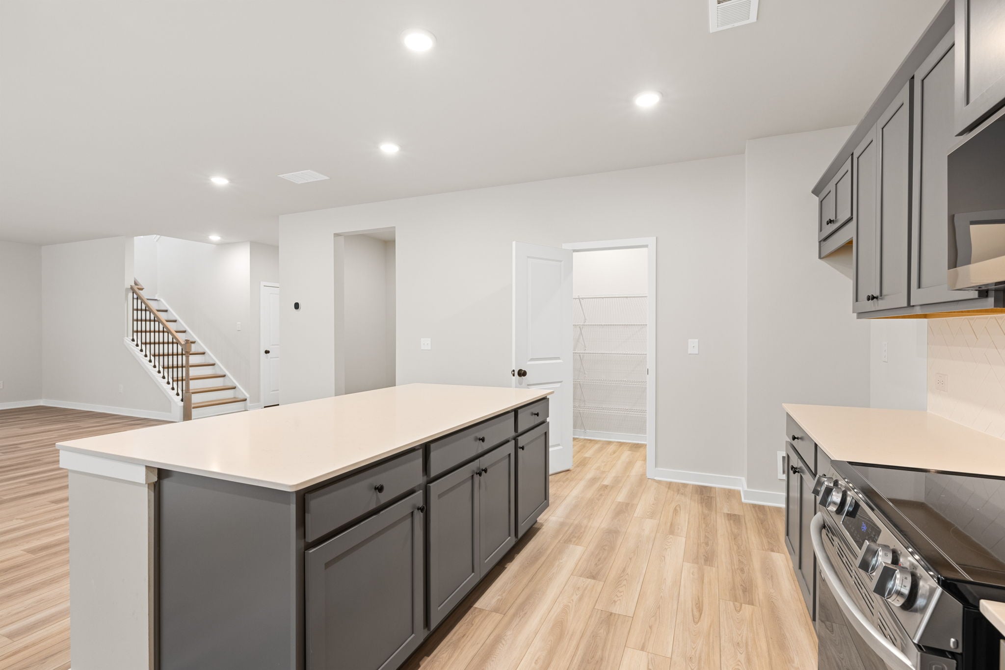 A kitchen with white cabinets.
