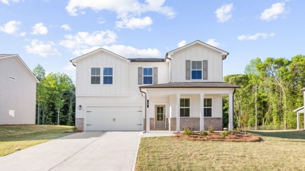 A white house with a driveway.