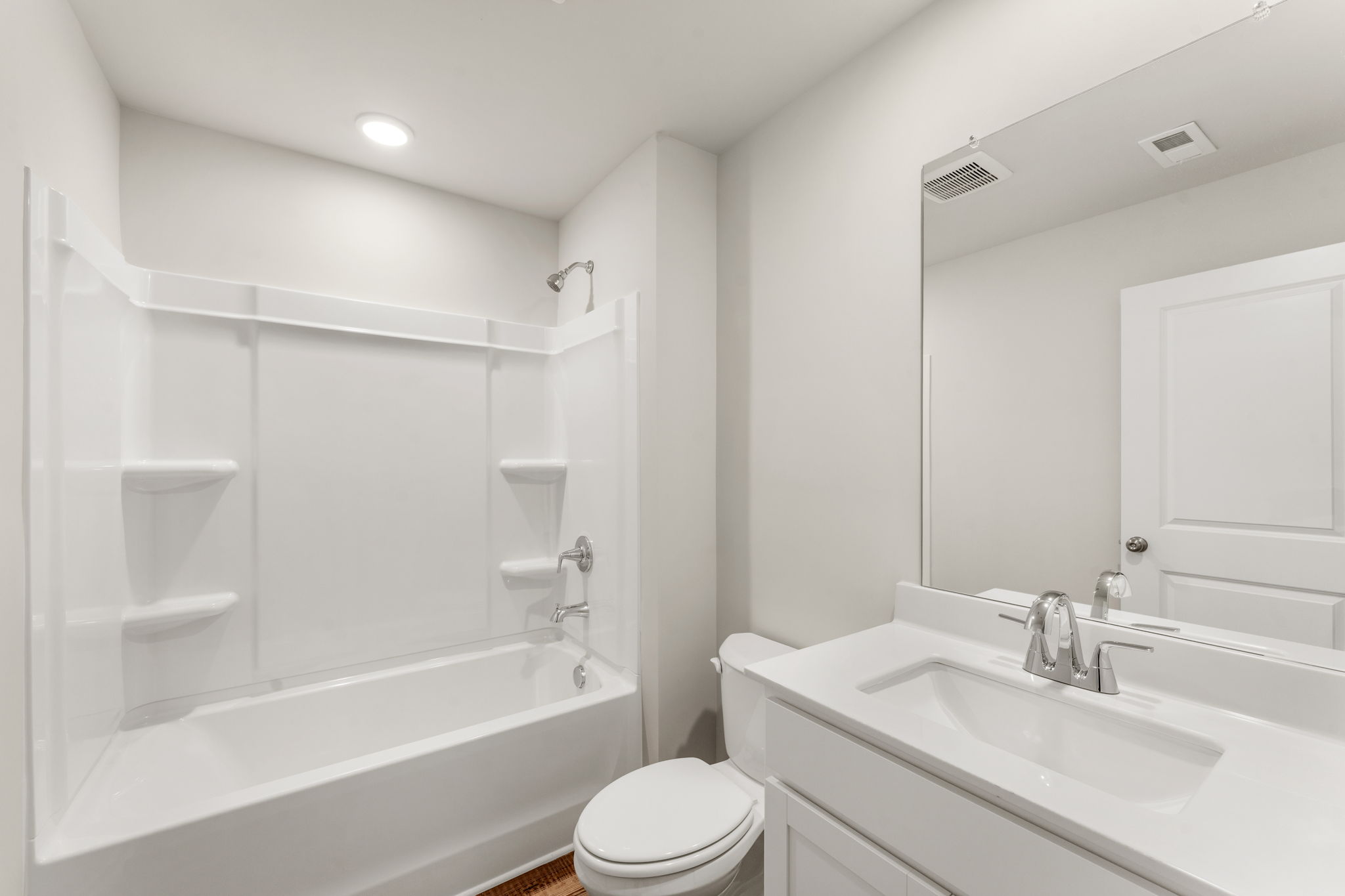 A bathroom with a tub sink and toilet.