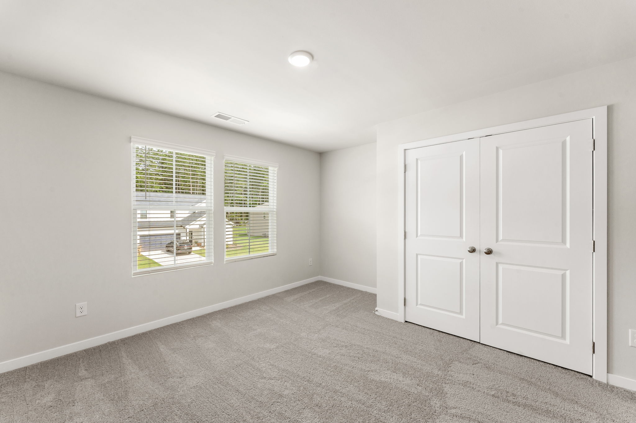 A room with white doors and a window.