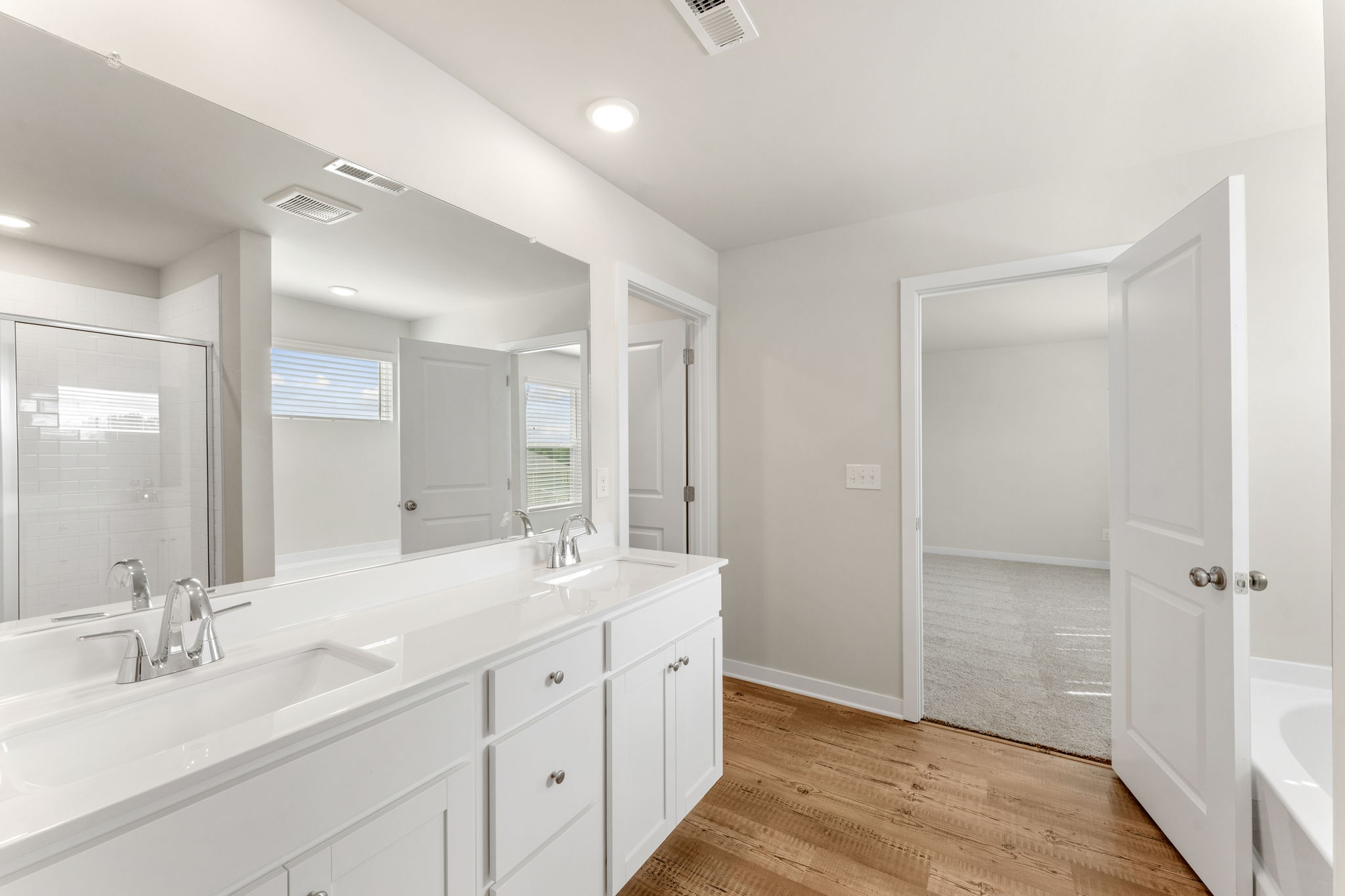 A bathroom with a tub sink and a shower.