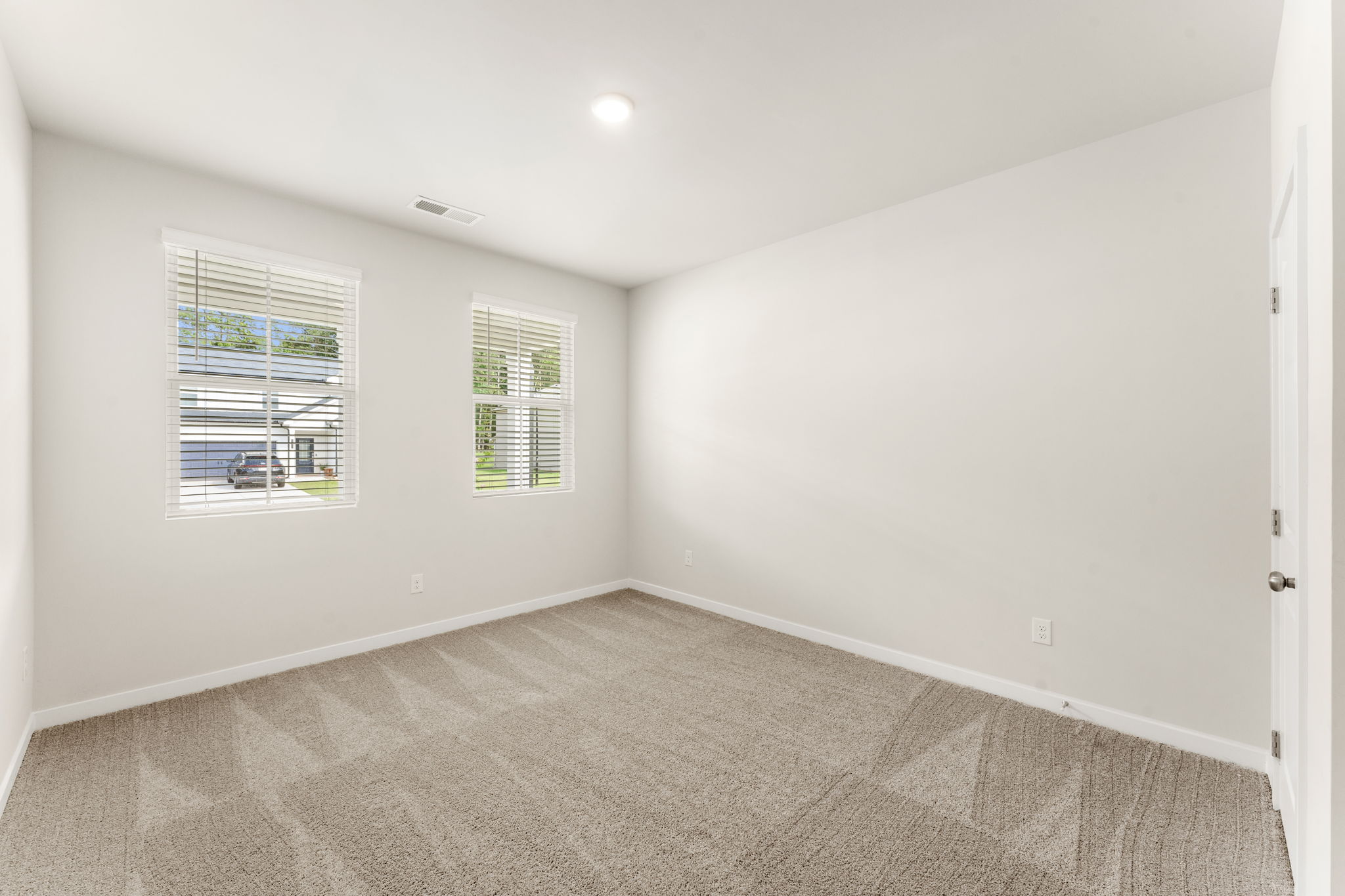 A room with a window and a door.