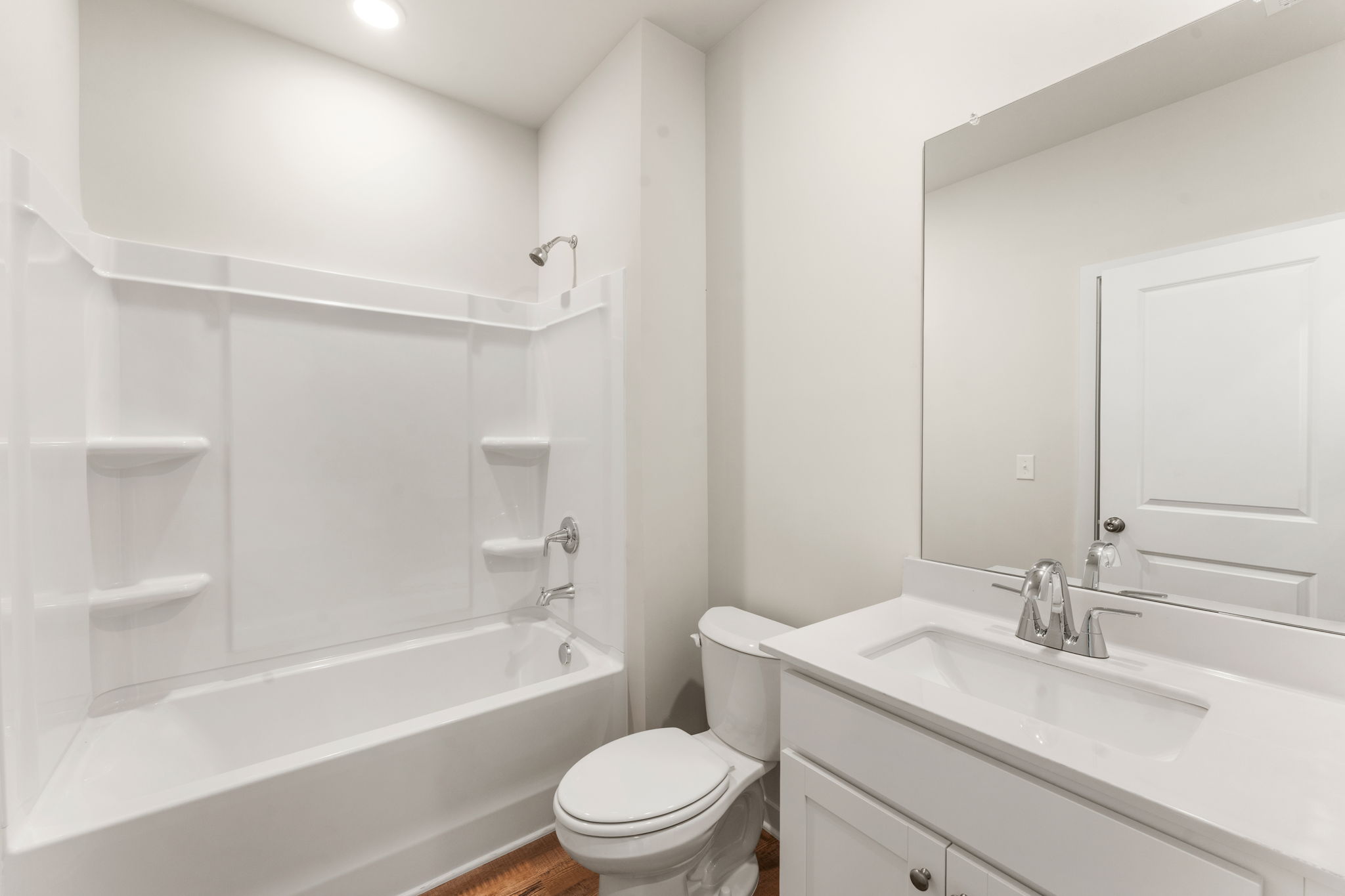 A bathroom with a tub toilet and sink.
