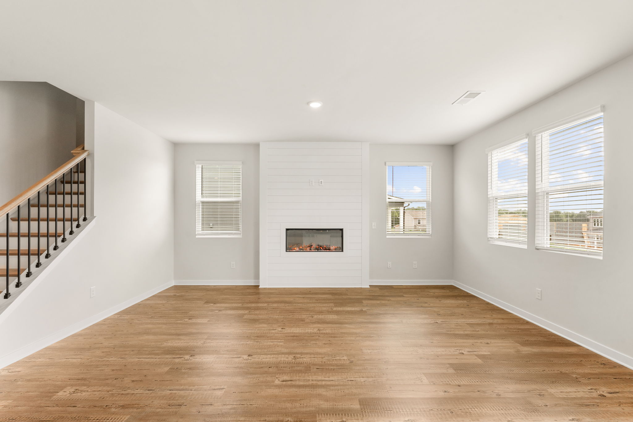 A room with white walls and a wood floor.