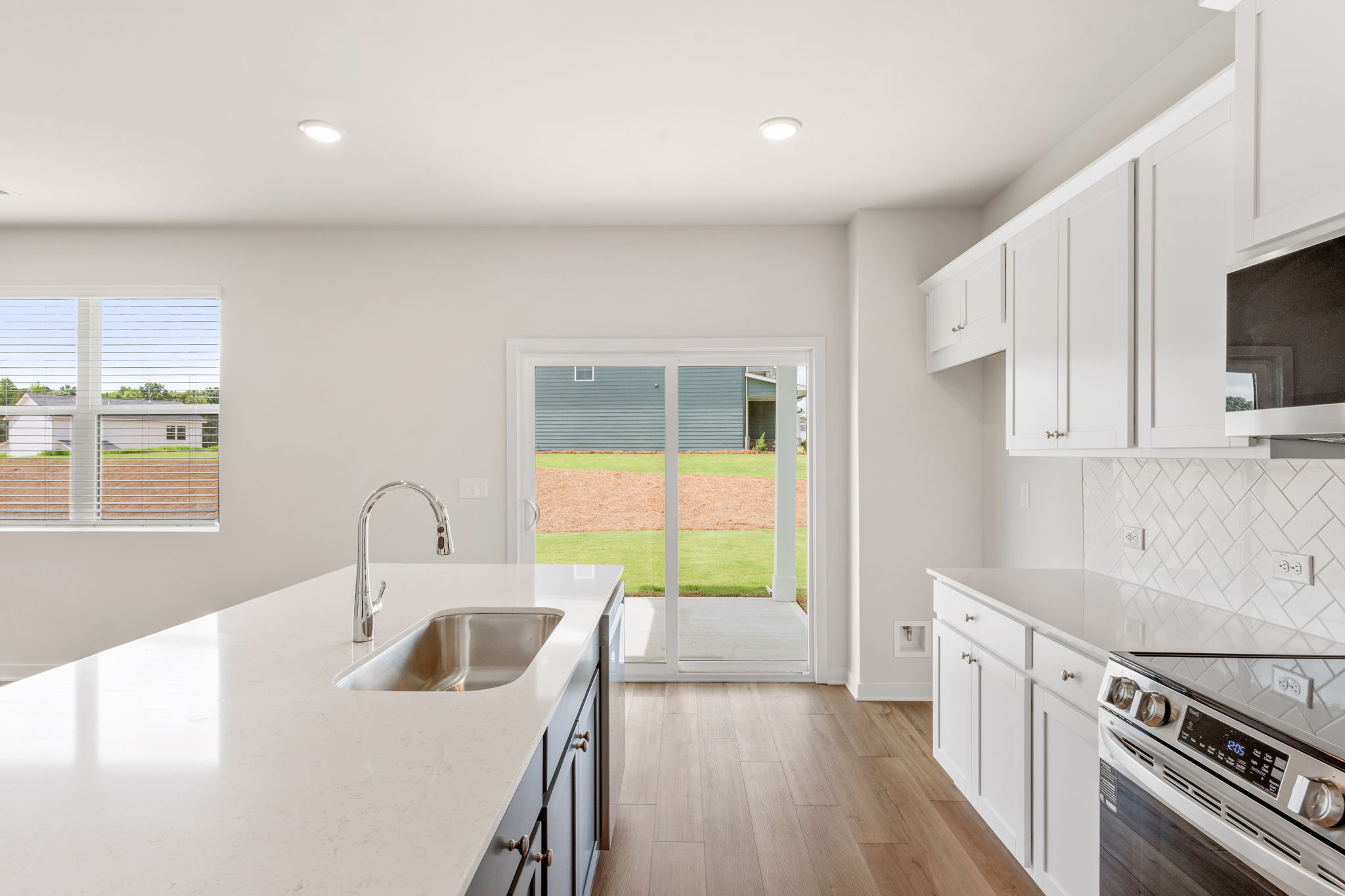 A kitchen with white cabinets.
