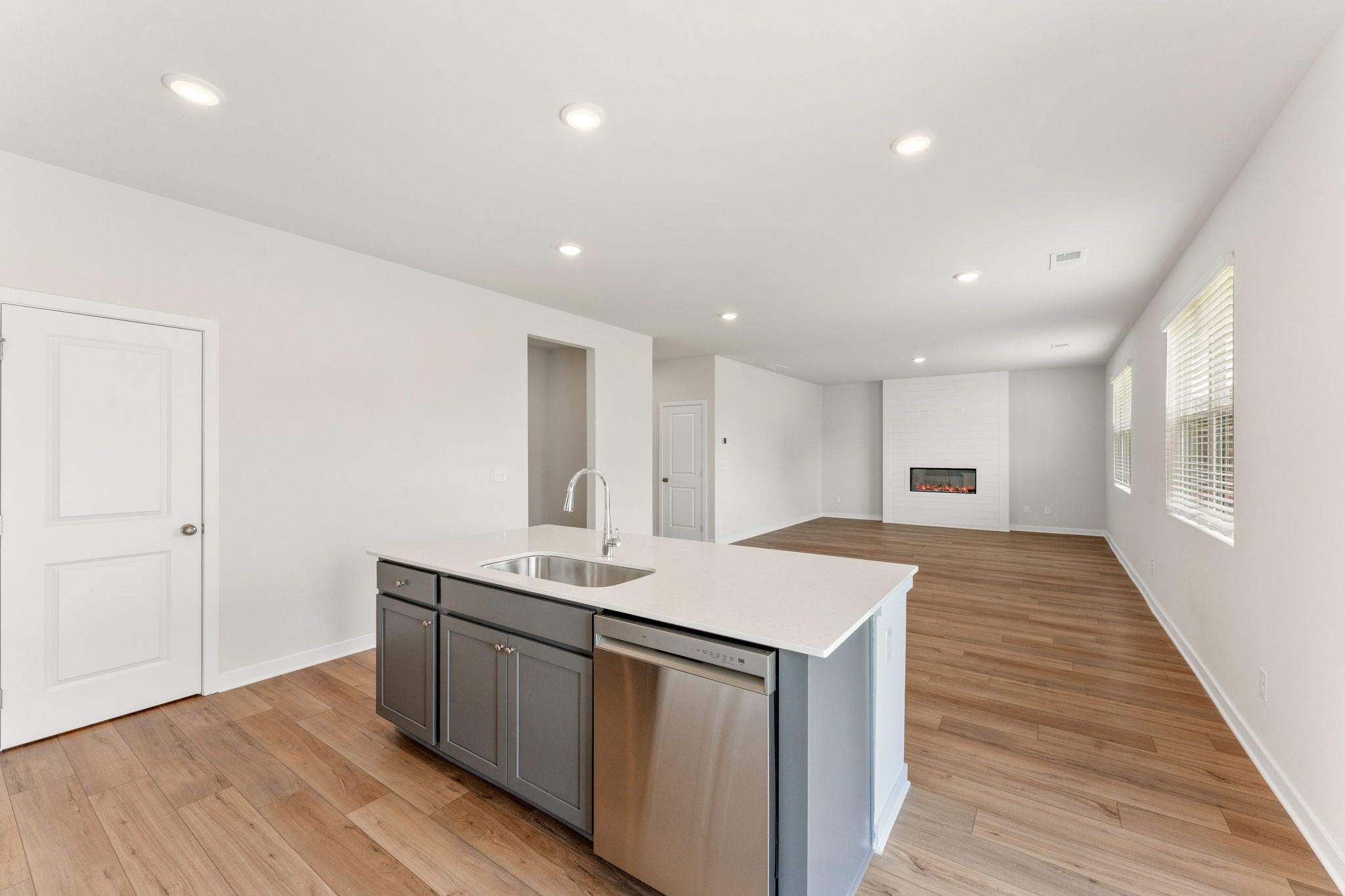 A kitchen with a wood floor.