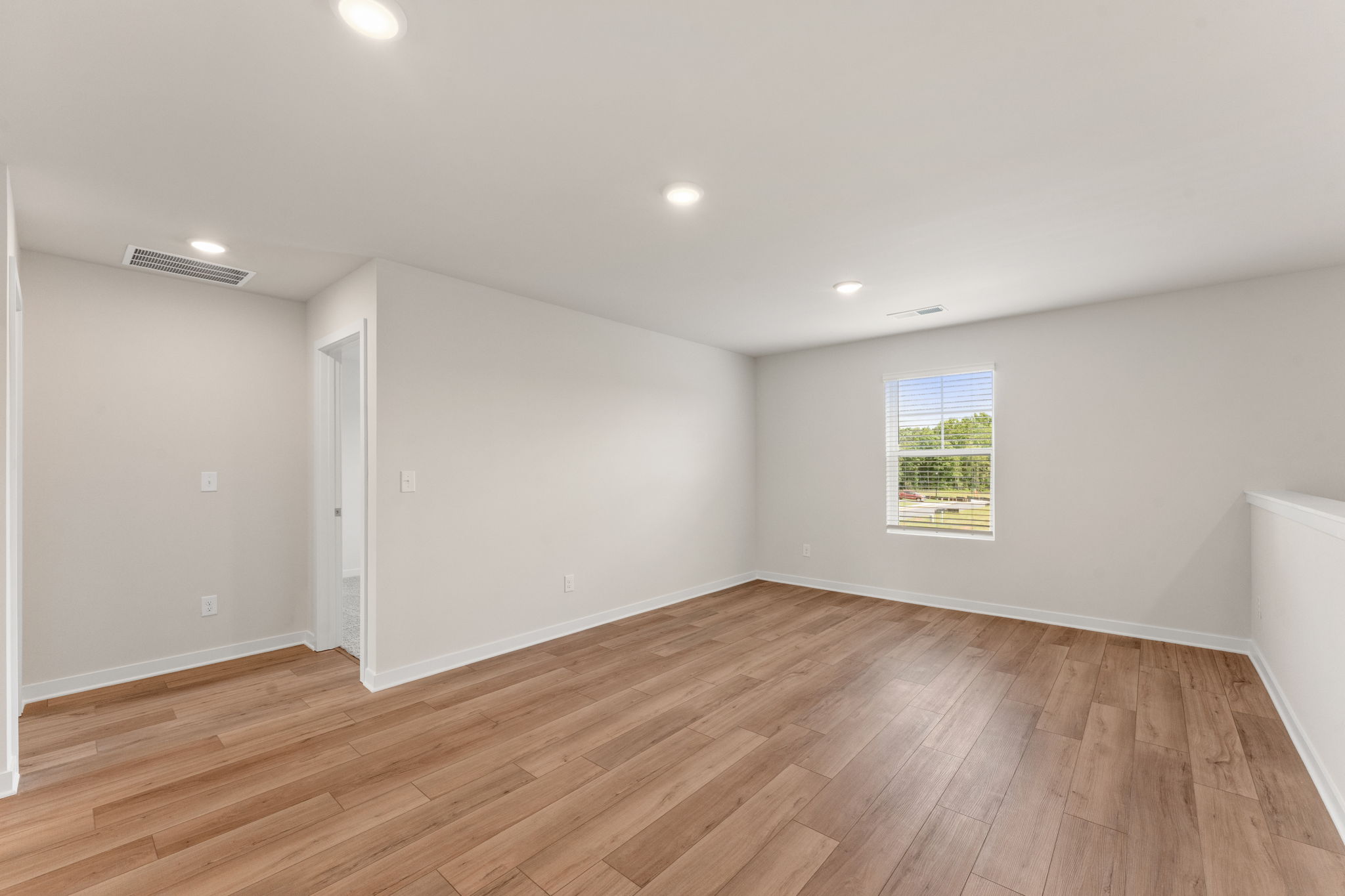 A room with a wood floor and a wood floor.